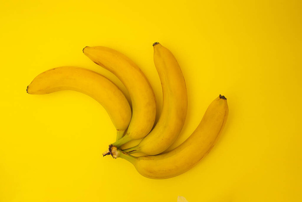 Bananas on yellow background, monochrome - Fotó, kép