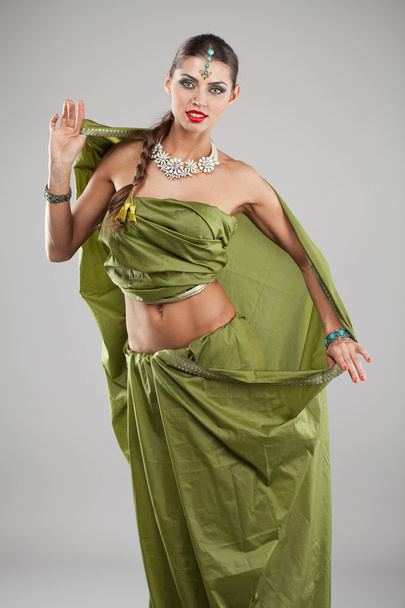 Young pretty woman in indian green dress - Фото, изображение