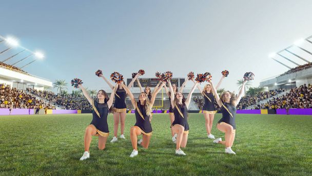 Group of cheerleaders in action on  stadium - Photo, Image