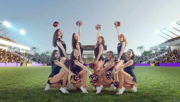 Groep cheerleaders in actie op stadion - Foto, afbeelding