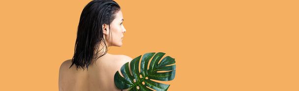 Beauty Woman with natural green palm leaf portrait. Fashion, beauty, make-up, cosmetics. - 写真・画像
