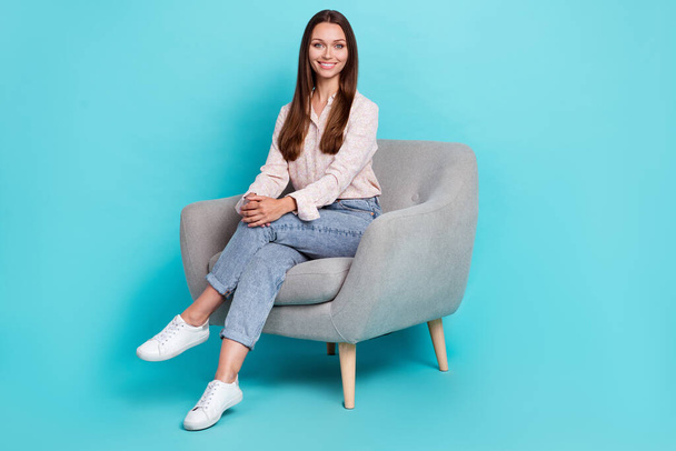 Full length photo of pretty positive lady stylish clothes outfit sit enjoy chair legs crossed empty space isolated on cyan color background. - Fotoğraf, Görsel