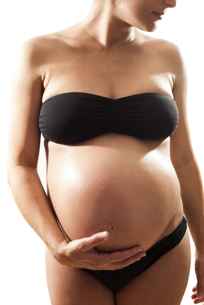 Pregnant touching her tummy - Photo, image