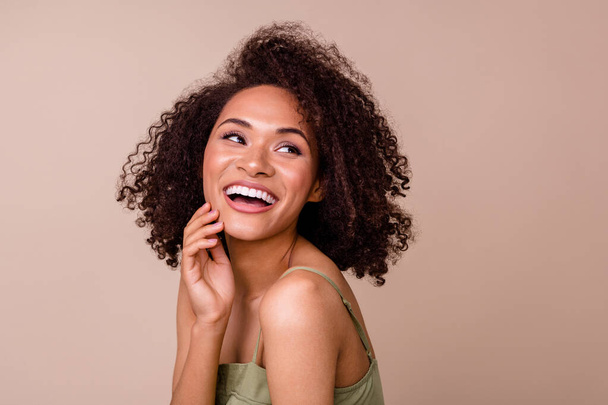 Close up photo of cheery young lady curly hair enjoy facial peeling effect dressed trendy khaki outfit isolated on beige color background. - Φωτογραφία, εικόνα