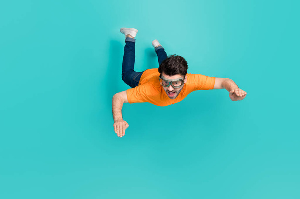 Full size photo of guy trying sky diving outdoors sport falling down isolated on cyan color background. - Fotografie, Obrázek
