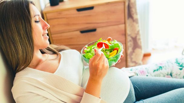 Pregnant salad healthy food. Pregnancy woman eating nutrition diet food salad. Family nutrition, healthy eating concept - Φωτογραφία, εικόνα