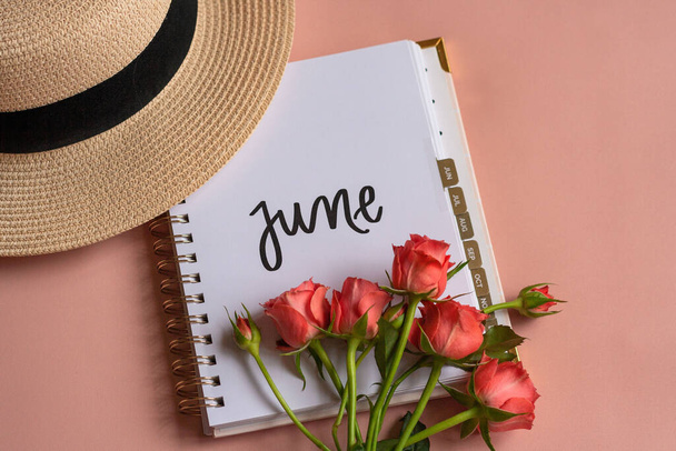 the summer month of june indicated in the notebook as a time for vacation, recreation and travel - 写真・画像