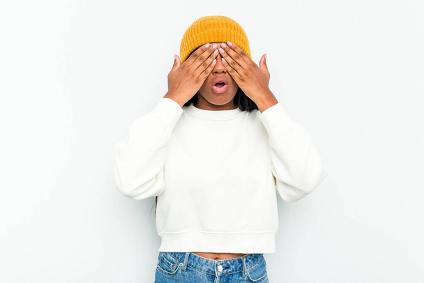 Young African American woman isolated on white background afraid covering eyes with hands. - Foto, afbeelding