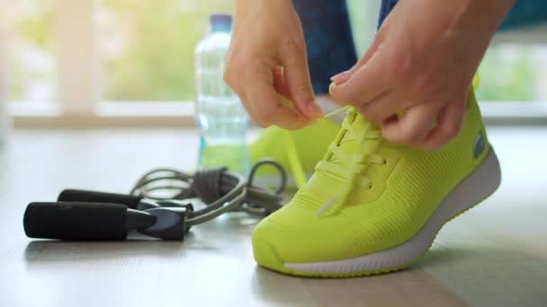 Woman tying shoelaces on sneakers going for training or jogging, close up. - Footage, Video
