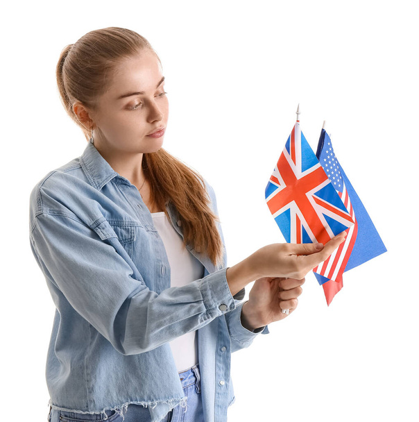 Young woman with different flags on white background - Photo, Image