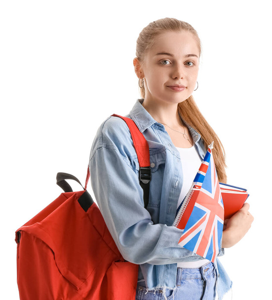Young woman with UK flag, books and backpack on white background - Fotoğraf, Görsel
