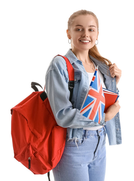 Young woman with UK flag, books and backpack on white background - Foto, Bild