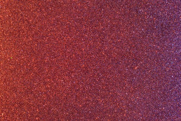 Background with sparkles. Backdrop with glitter. Shiny textured surface. Dark moderate red. Mixed neon light - Photo, image
