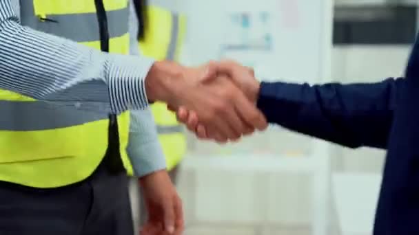 Competent businessman and engineer shake hands after successfully concluding a trading arrangement or business meeting. - Materiaali, video