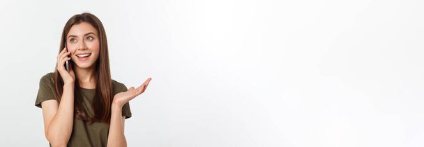 Laughing woman talking and texting on the phone isolated on a white background - Photo, Image