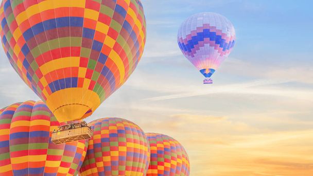 landscape scenery of multi color hot air balloon flying up over sunrise sky - 写真・画像