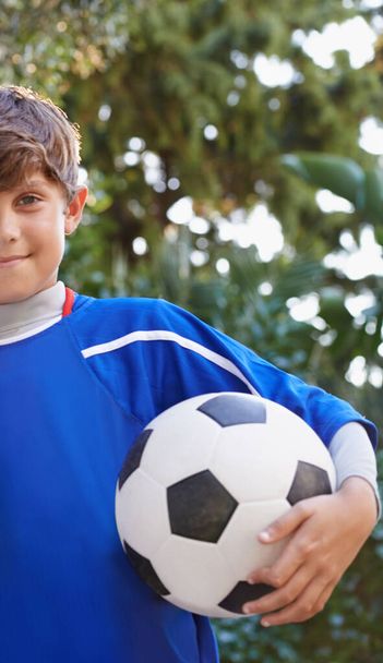 A ball is all he needs. Cropped portrait of a young boy holding a soccer ball - 写真・画像