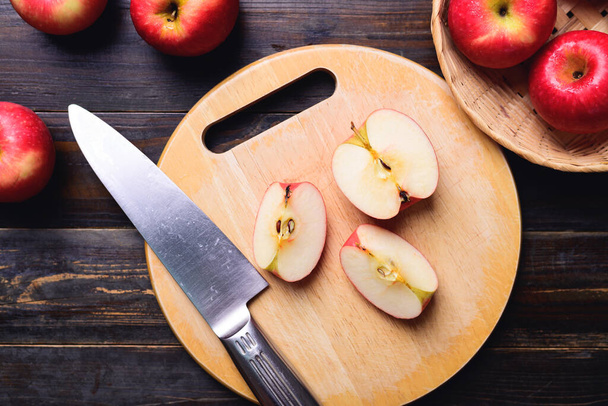 Sliced red apple on cutting wooden board, Healthy eating, Table top view - Zdjęcie, obraz
