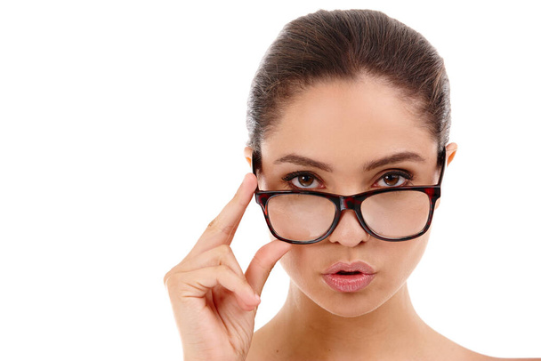 You better watch out...a beautiful woman standing in a studio while wearing glasses - 写真・画像