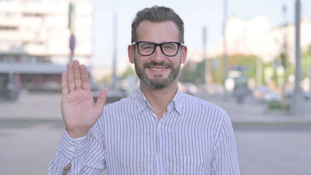 Welcoming Adult Man Waving Hand for Hello Outdoor - Photo, Image