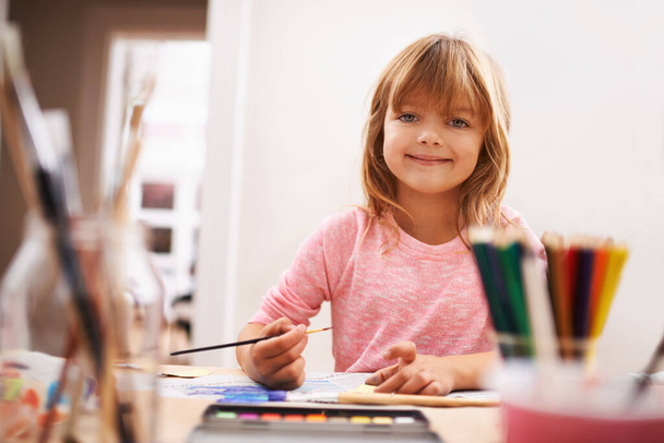 Shes so creative. Portrait of a little girl painting at school - Fotó, kép