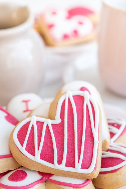 Close-Up of an Assortment of Heart Shaped Cookies on a Plate Set on a White Table  Vertical - Zdjęcie, obraz