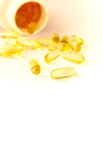 Fish oil pills. Omega 3 gel capsules with bottle on blurred background. - Valokuva, kuva