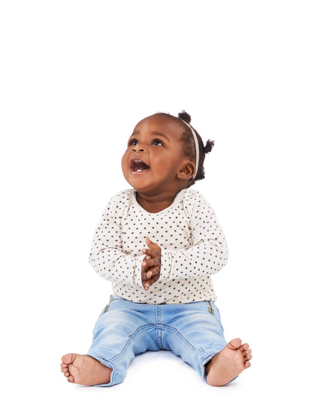Encore. Studio shot of a happy baby girl sitting against a white background - Fotó, kép