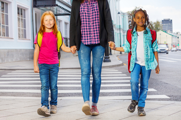 Kids with woman walking on street - 写真・画像