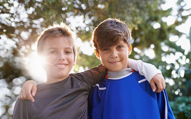 Brothers and friends. Cropped portrait of two young brothers standing together outdoors - Foto, imagen