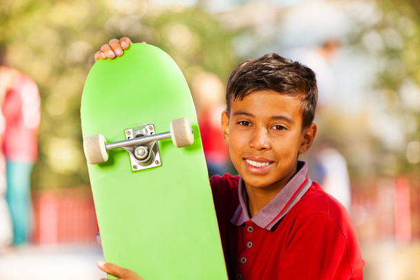 Boy with green skateboard - Foto, Imagen