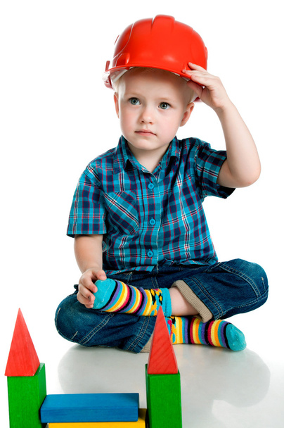 Little boy in a red construction helmet - Foto, afbeelding