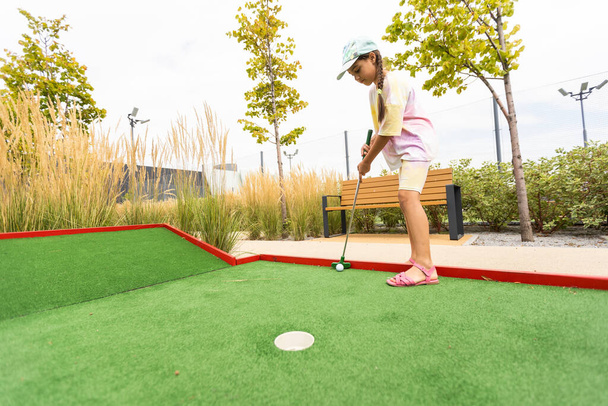 cute little girl on a miniature golf course. - Foto, immagini