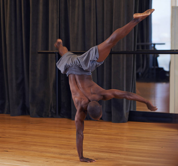 Showing off what his body can do. Full length shot of a male dancer performing during a dance audition - Fotoğraf, Görsel