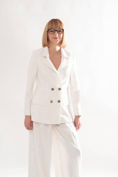 Confident businesswoman in white formal suit on background - Valokuva, kuva