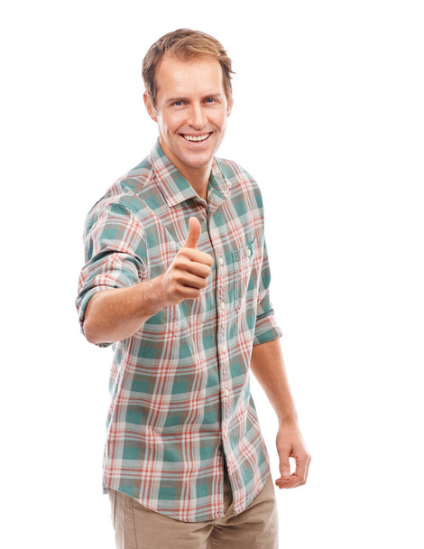 Youve got my approval. Portrait of a handsome young man gesturing thumbs up against a white background - Fotó, kép
