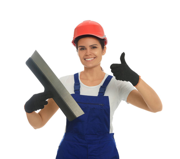 Professional worker with putty knife in hard hat on white background - Foto, afbeelding