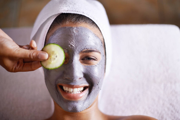 Just what my skin needs. a young woman enjoying a facial treatment at a spa - Fotó, kép