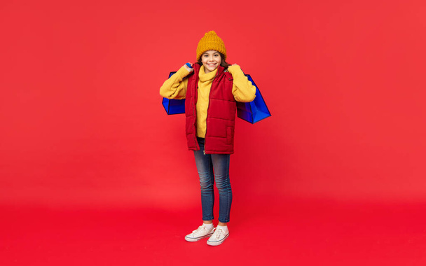 happy birthday holiday. black friday discount. seasonal christmas sales. cheerful teen girl in with shopping bag. present and gifts buy. shopping child with purchase. kid with package. - Photo, image