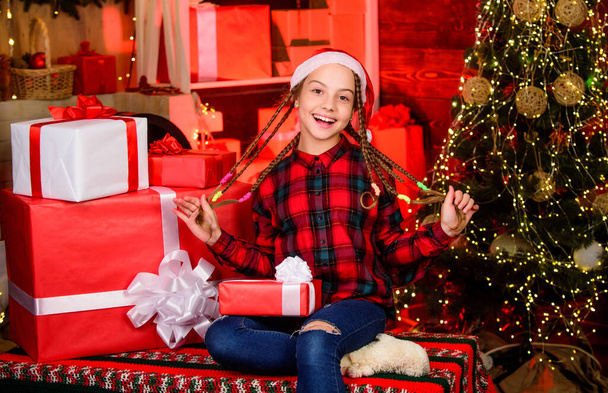 Happy kid with gift christmas tree. Childhood gift we always wanted. Childhood memory nicest gift prompts festive cheer. Cherished dreams concept. Finally new year. Teen girl celebrate christmas. - 写真・画像