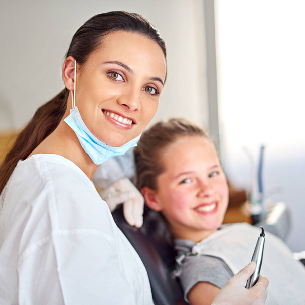 She takes good care of her young patients. Portrait of an attractive female dentist and her child patient - Foto, Imagem