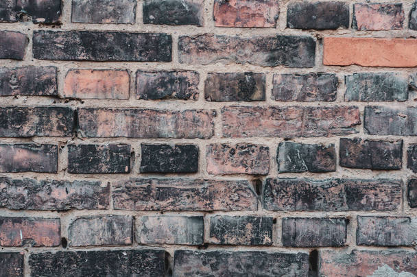 Dirty red grunge brick wall, close-up, grungy texture of blackened brick. - 写真・画像
