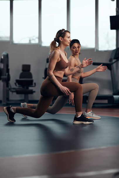 Mujeres guapas haciendo ejercicio en un gimnasio. Señoras adultas con hermosos cuerpos en forma. - Foto, imagen