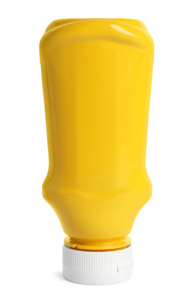 Spicy mustard in plastic bottle isolated on white - Fotó, kép