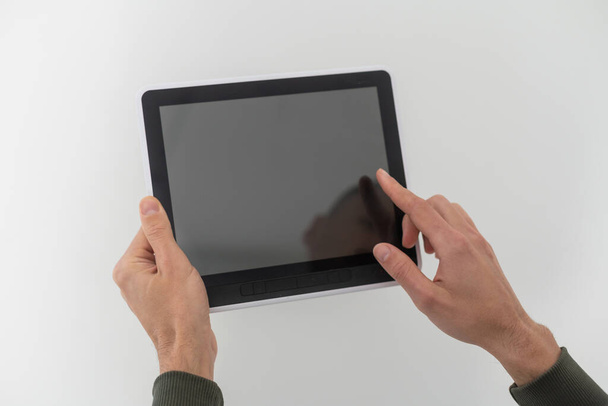 hands of a man holding blank tablet device - Φωτογραφία, εικόνα