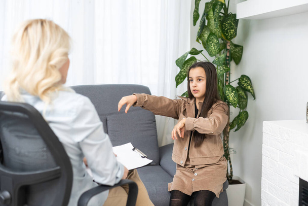 Young female psychologist talk with girl teenager. Caring woman social worker have meeting with teen schoolgirl. - Photo, Image