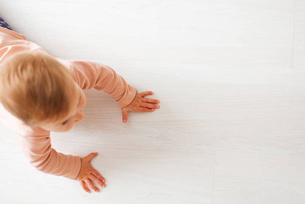 baby on wood floor learning to crawl on floor - Foto, imagen