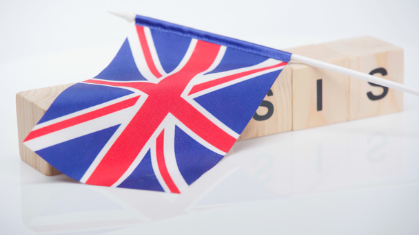 British flag on wooden cubes with crisis lettering on white background - Photo, Image