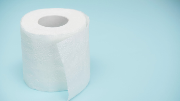 мягкая и белая туалетная бумага на синем фоне  - Фото, изображение