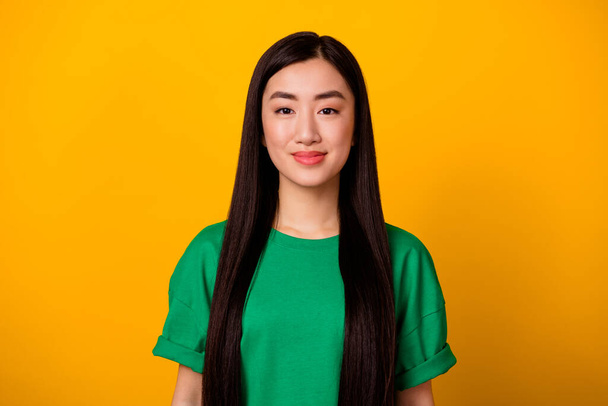 Portrait of young adorable nice lady with long silky soft keratin straightened hair isolated on yellow color background. - Photo, image